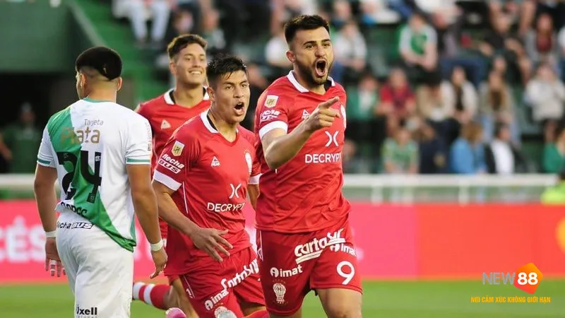 Cầu thủ Huracan vượt qua phòng ngự của Banfield trong trận đấu bóng đá
